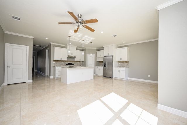 kitchen featuring stainless steel appliances, a kitchen island, white cabinetry, backsplash, and pendant lighting