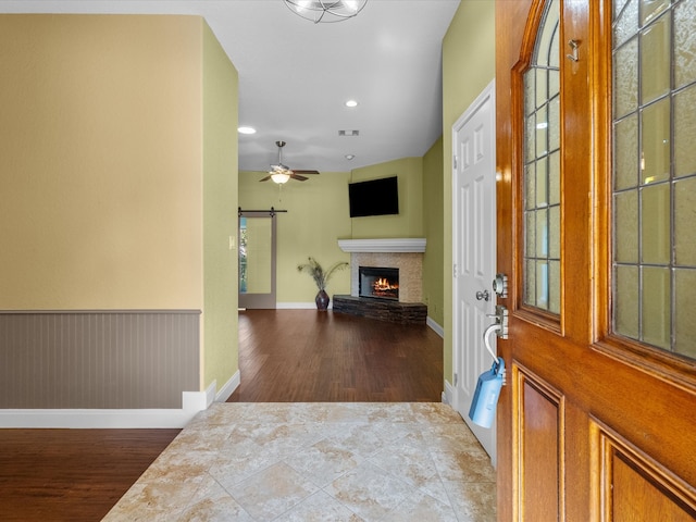 foyer entrance featuring a barn door and hardwood / wood-style flooring