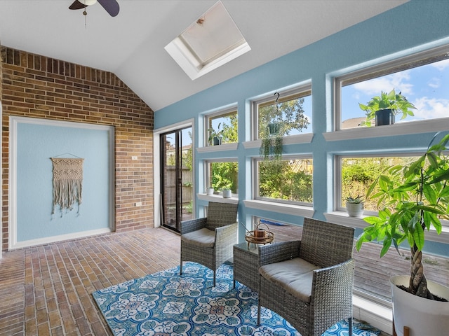 sunroom featuring lofted ceiling with skylight, ceiling fan, and a healthy amount of sunlight