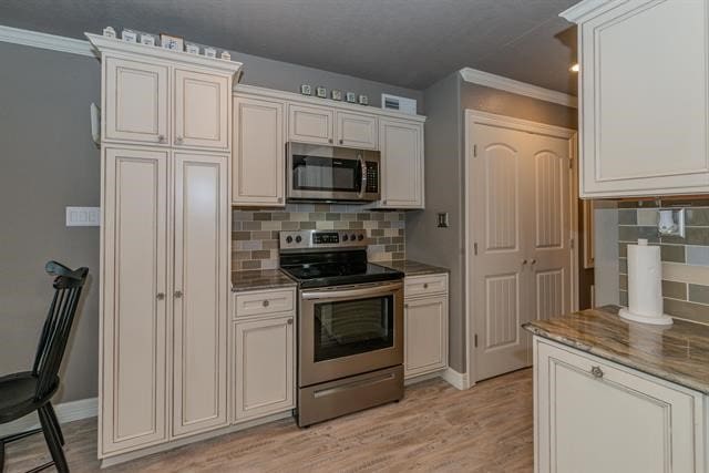 kitchen featuring tasteful backsplash, appliances with stainless steel finishes, crown molding, and light hardwood / wood-style flooring