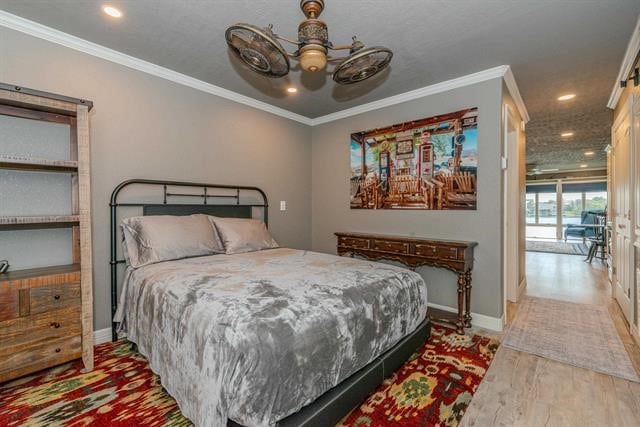 bedroom with ceiling fan, light hardwood / wood-style flooring, and crown molding