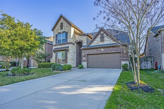 view of front of home with a garage and a front lawn