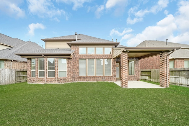 back of house with a lawn and a patio area