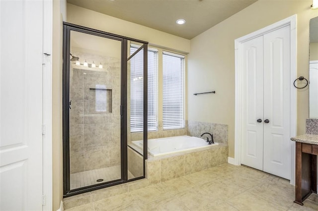 bathroom featuring tile patterned flooring, vanity, and plus walk in shower