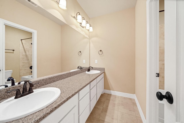 bathroom with tile patterned floors, vanity, and tiled shower / bath combo