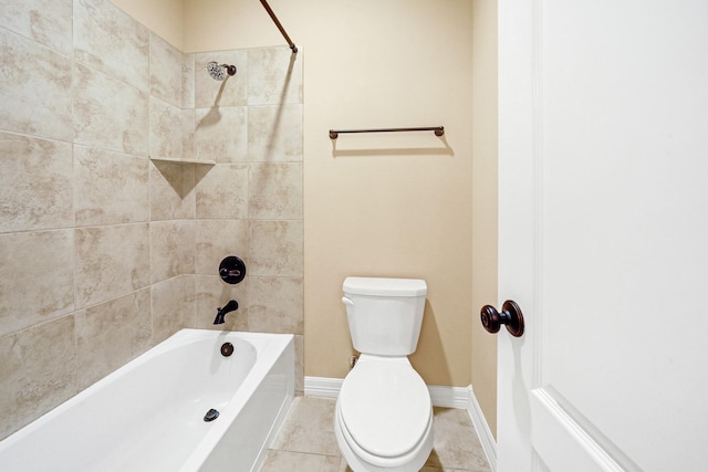 bathroom with tile patterned floors, tiled shower / bath combo, and toilet