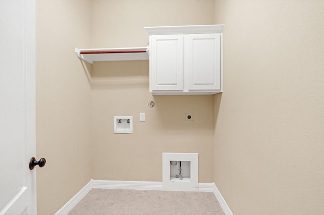 clothes washing area featuring hookup for an electric dryer, gas dryer hookup, light tile patterned floors, and hookup for a washing machine