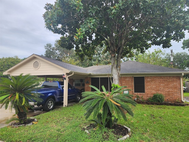 single story home featuring a carport and a front lawn