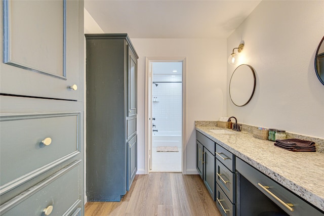 9932 Shady Dr, Houston, TX 77016 - bathroom with wood finished floors, vanity, bathtub / shower combination, and baseboards
