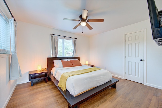 9932 Shady Dr, Houston, TX 77016 - bedroom with light wood finished floors, baseboards, and a ceiling fan