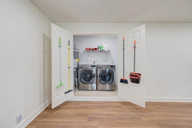 9932 Shady Dr, Houston, TX 77016 - laundry room with washing machine and clothes dryer, wood finished floors, and baseboards