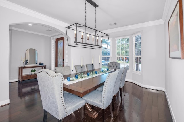 dining area with dark hardwood / wood-style flooring and crown molding