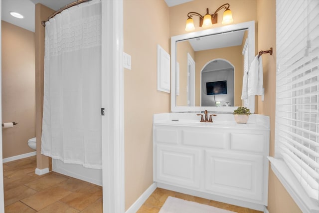 full bathroom with vanity, toilet, and shower / tub combo with curtain