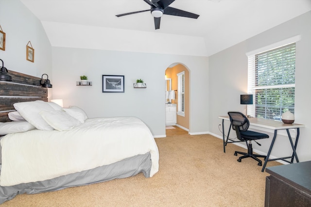 bedroom with ceiling fan, light colored carpet, and vaulted ceiling