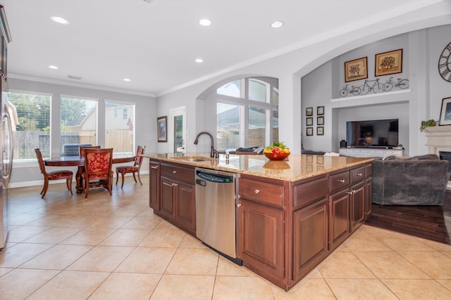 kitchen featuring light tile patterned flooring, light stone counters, stainless steel dishwasher, and sink