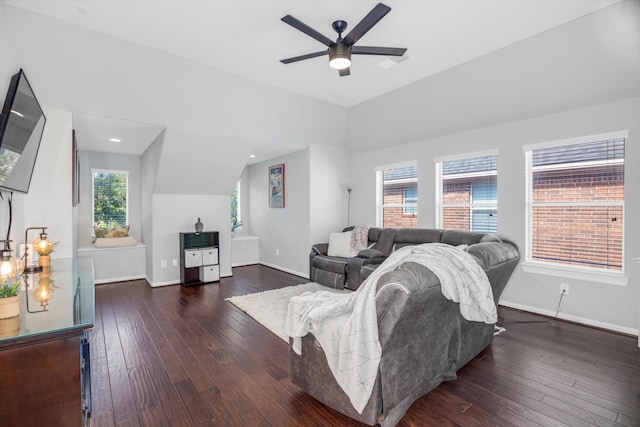 living room with vaulted ceiling, plenty of natural light, and dark wood-type flooring