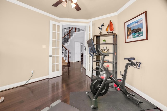 exercise area with ceiling fan, french doors, dark wood-type flooring, and ornamental molding