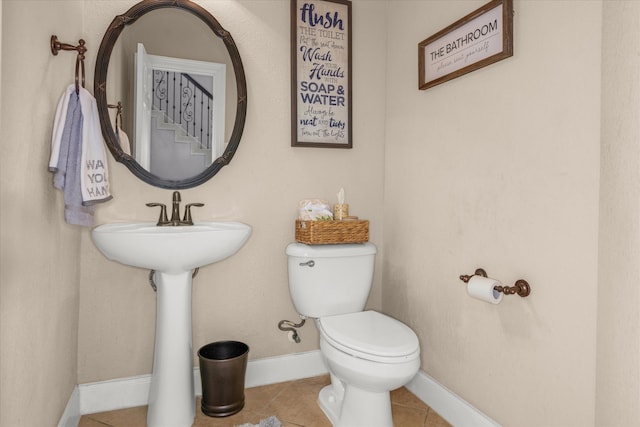 bathroom featuring tile patterned flooring and toilet