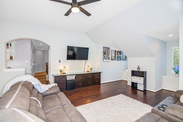 living room featuring ceiling fan, dark wood-type flooring, and vaulted ceiling