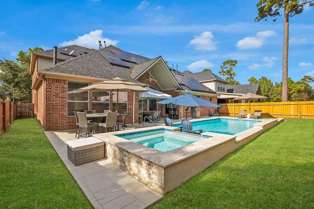 view of swimming pool with an in ground hot tub, a yard, and a patio