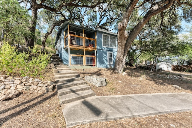 view of front of home featuring a balcony