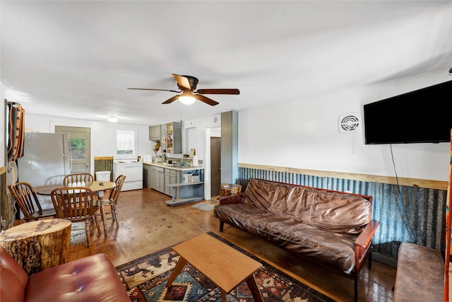 living room with ceiling fan, concrete floors, and washer / clothes dryer