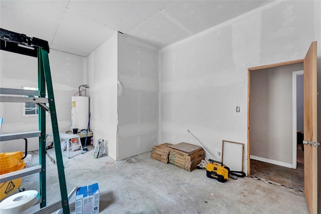 interior space with concrete floors and water heater