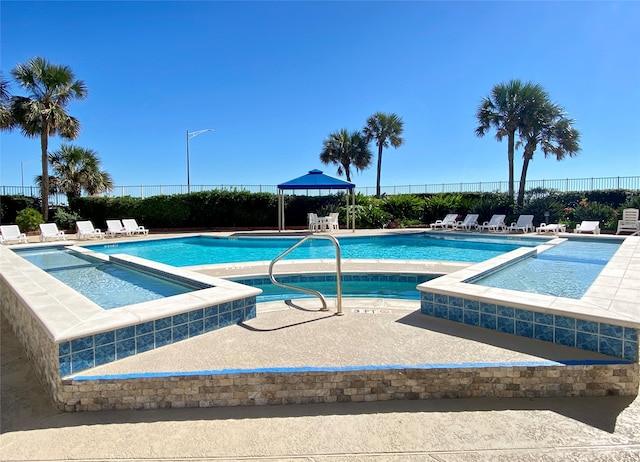 view of swimming pool with a community hot tub