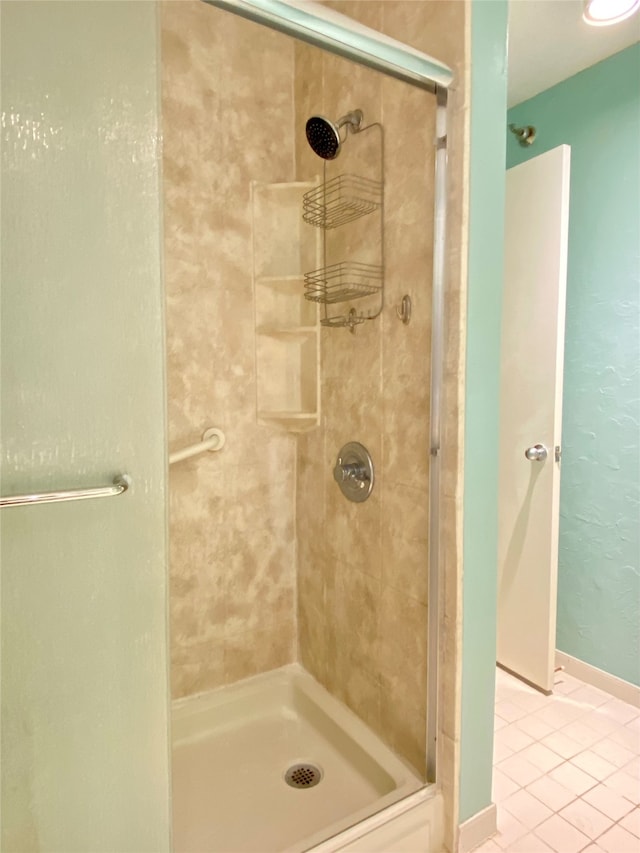 bathroom featuring tile patterned floors and a shower with door