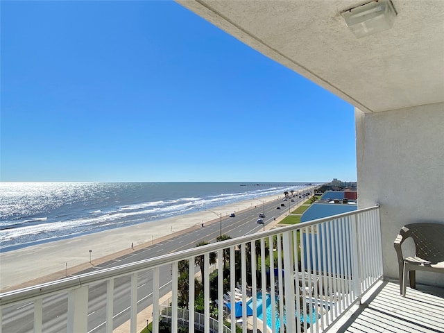 balcony with a view of the beach and a water view