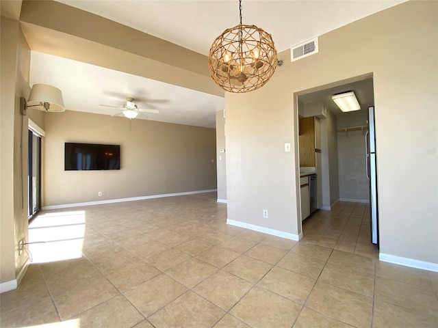 spare room with ceiling fan with notable chandelier and light tile patterned flooring