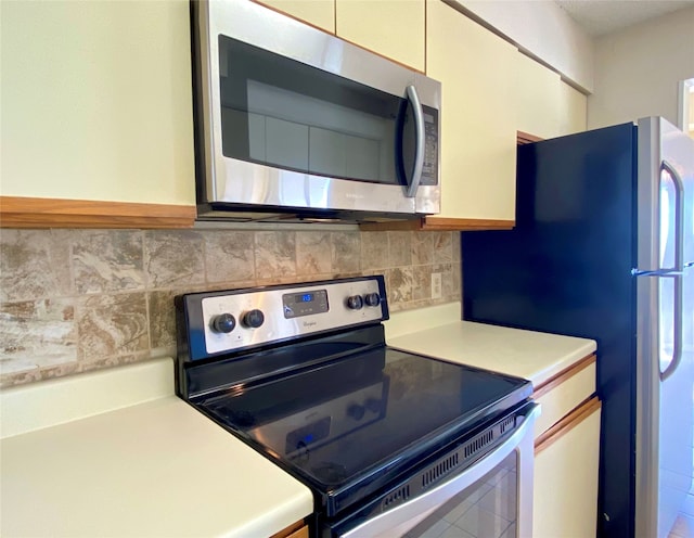 kitchen with decorative backsplash and appliances with stainless steel finishes