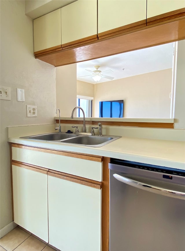 kitchen featuring light tile patterned floors, stainless steel dishwasher, ceiling fan, and sink