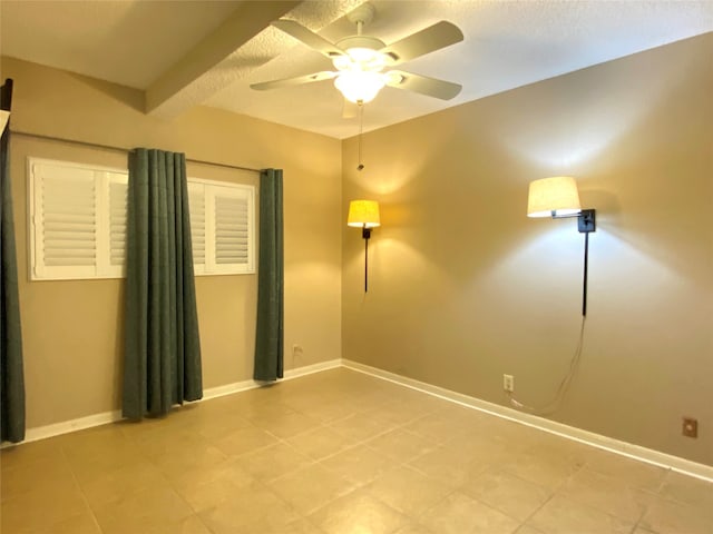 unfurnished room with beamed ceiling and ceiling fan