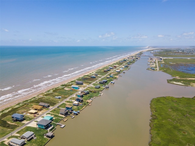 birds eye view of property featuring a water view and a beach view