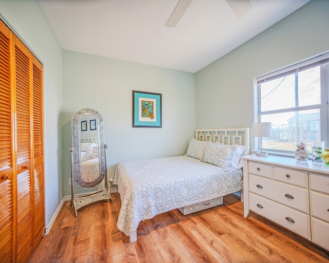 bedroom with a closet, ceiling fan, and light hardwood / wood-style flooring