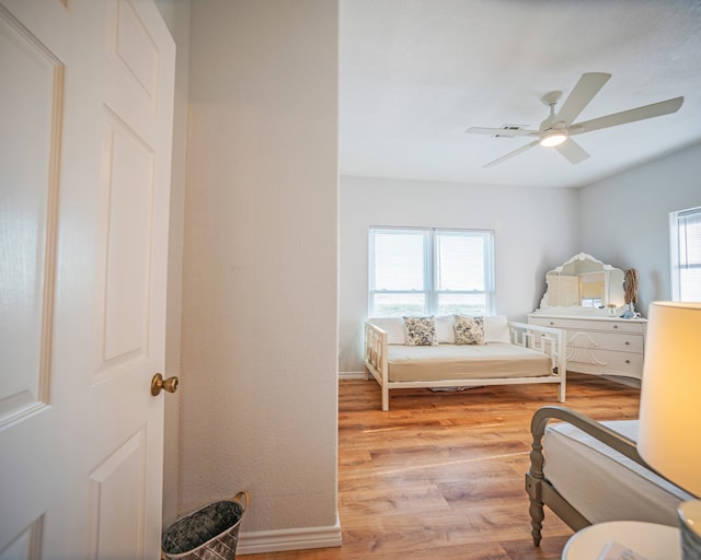 bedroom featuring light hardwood / wood-style floors, multiple windows, and ceiling fan