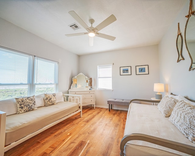 bedroom with ceiling fan and light hardwood / wood-style flooring