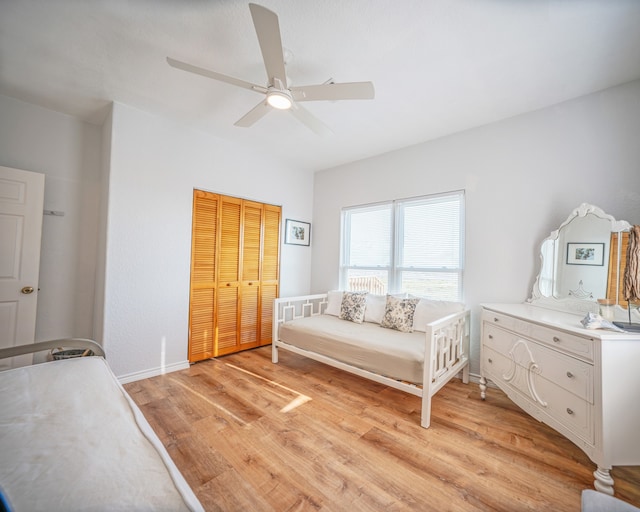 bedroom featuring ceiling fan, a closet, and light hardwood / wood-style flooring