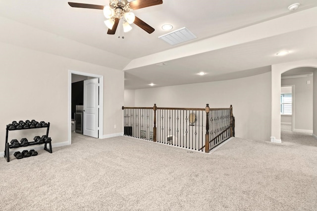 spare room featuring light carpet and ceiling fan