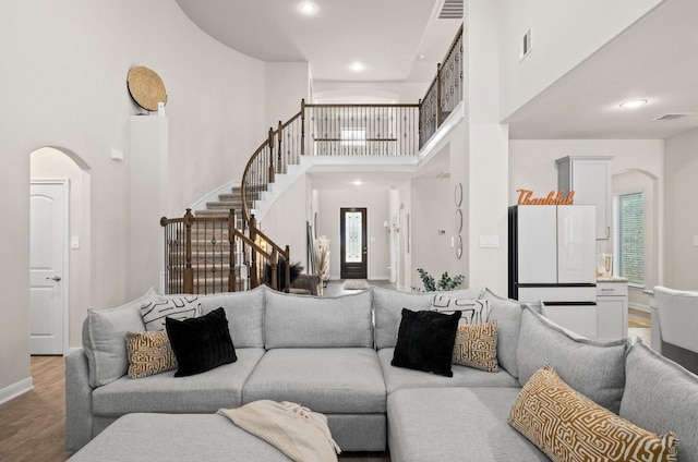 living room with a high ceiling and hardwood / wood-style floors