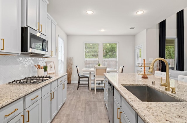 kitchen featuring light hardwood / wood-style floors, sink, a healthy amount of sunlight, and stainless steel appliances