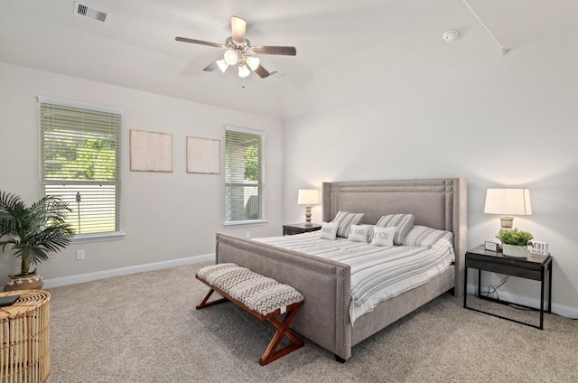 carpeted bedroom with ceiling fan and multiple windows