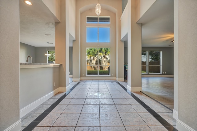 foyer entrance featuring ceiling fan, sink, a textured ceiling, and light parquet flooring