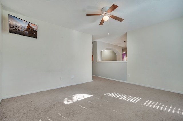 carpeted spare room with ceiling fan