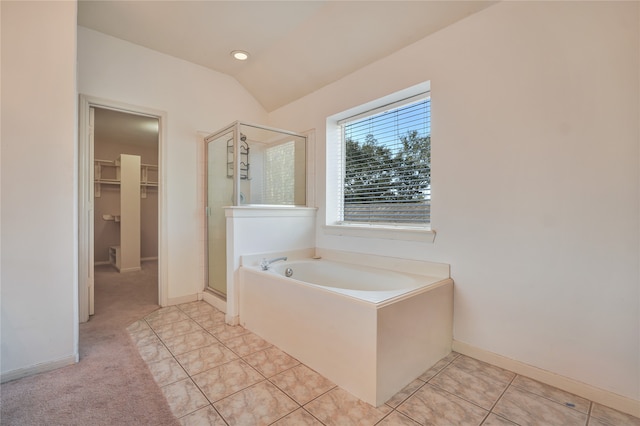 bathroom with tile patterned flooring, independent shower and bath, and vaulted ceiling