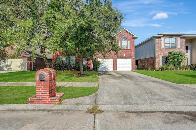 view of front of home featuring a front yard and a garage