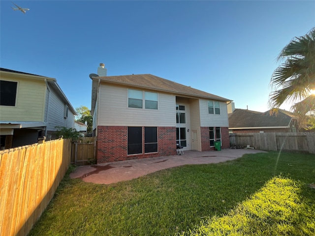 rear view of property featuring a yard and a patio