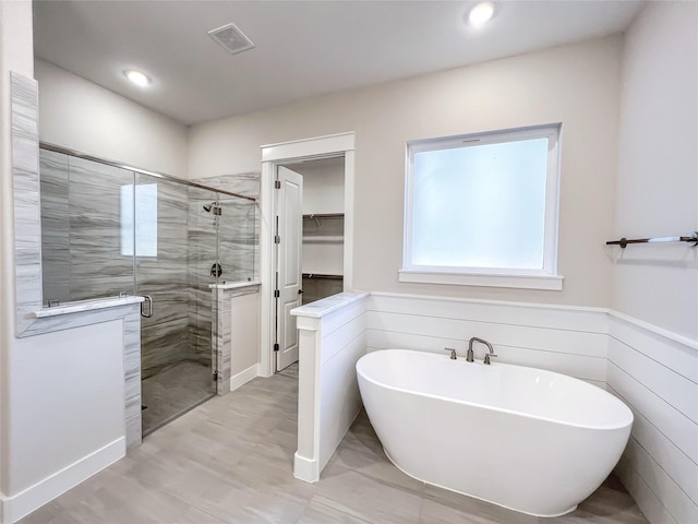 bathroom with shower with separate bathtub