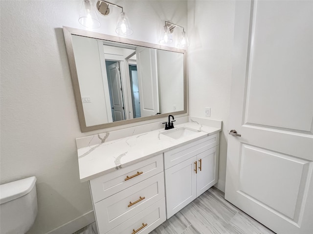 bathroom featuring vanity and toilet